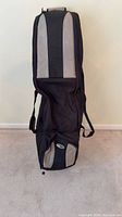 Full view of black and gray Bag Boy travel golf bag standing upright