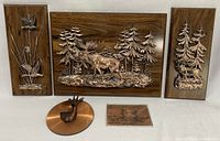 Group view of all five copper relief wall hangings