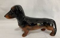 Side view of glazed ceramic dachshund figurine