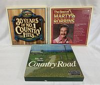 Front view of three country music vinyl box sets