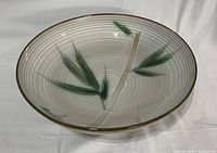 Top view of ceramic serving bowl showing bamboo leaf design and concentric texture
