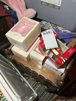 Stack of five Hallmark ornament boxes on small table
