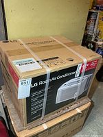 Sealed LG LW6017R window AC carton on pallet