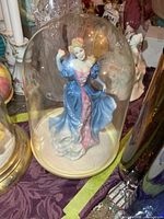 Figurine enclosed in clear dome on base