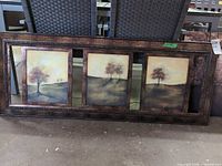 Entire triptych showing three panels within full wood frame