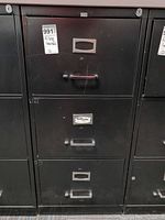 Front view of black 3-drawer metal filing cabinet