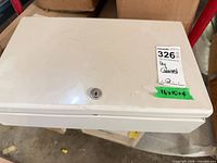 closed white metal key cabinet showing cylinder lock and size label