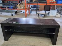Front view of coffee table with glass shelf visible