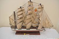 Starboard broadside view showing full sails, rigging and hull colors