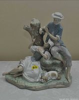 Front view of Lladro porcelain couple figurine with dog, shows overall design and condition