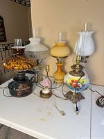 Group shot of all six converted oil lamps showing different styles, shades and cords