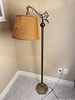 Full view of bridge floor lamp with shade and base visible