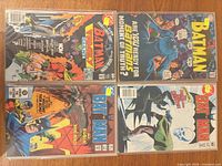 Group shot of all four bagged and boarded Batman-related comic books
