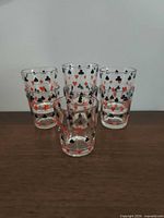 Front view of five of the glasses showing playing card suit pattern