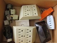 Box view of mixed outlet adapters showing quantities and colors