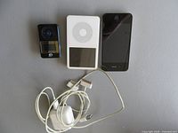 Front view of GPX player, iPod, iPhone and two cables