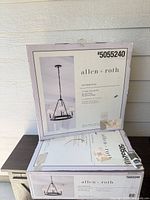 Two sealed boxes of allen + roth Sevierville chandeliers showing labels