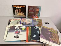 Front view showing full lot of LPs spread on table; key covers visible
