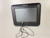 Front view of Monoprice TW460 tablet with USB cable