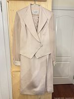 Full view of jacket and skirt on hanger
