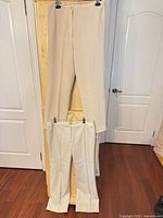 Both pairs of trousers displayed hanging