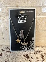 Front of backing card showing two necklaces and charms