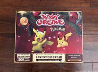 Front view of Pokémon Merry Christmas Advent Calendar jigsaw puzzle box showing Pikachu imagery and piece count