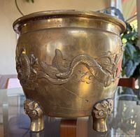 Full frontal view of bronze jardinière on tripod feet