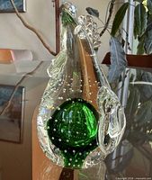 Front view of clear glass rooster with green core and controlled bubbles