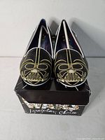 Front view of flats on box showing Darth Vader embroidery