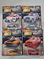Front view of all four Hot Wheels Boulevard cars in packaging