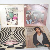 Front covers of four records including Grass Roots and Bruce Springsteen