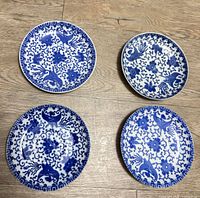 Top view of four blue and white plates showing design