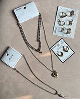 Full set showing two necklaces, ring card and earring card