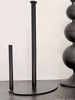 paper towel holder upright on flat surface