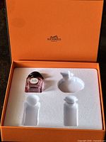 Open box showing foam insert and empty bottle