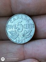 Reverse side showing CANADA FIVE CENTS 1927 and maple leaves