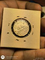 Reverse of 1947 5-cent coin showing beaver design in stapled flip