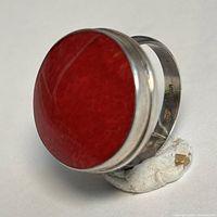 side view showing red coral cabochon and silver bezel