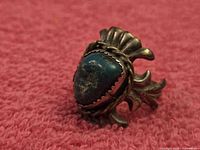 Front view of sandcast sterling ring with turquoise cabochon