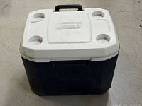 Front angled view showing lid with cup holders, body colour, and handle