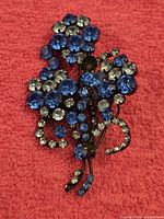 Front view showing blue and clear rhinestone floral design