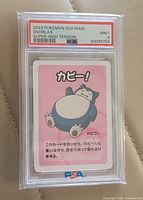 Front of PSA slab showing grade label and Snorlax card front