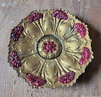 Top view showing gold and red painted floral design on tray