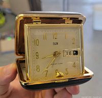 Clock open showing dial, hands, day-date window