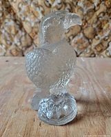 Front view of clear glass eagle statue on pedestal base