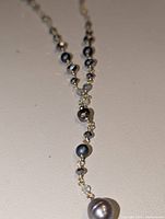 Full view of necklace showing Y-drop design and beads