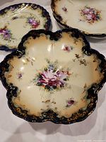 Five-lobed Nippon serving bowl, cream ground, cobalt rim, floral center, gold gilt scrolls