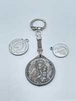 Front of keychain medal and two small medals