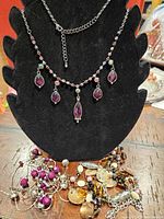 All three necklaces displayed; silver pendant necklace on bust, two bead necklaces below